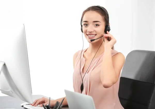 Female consulting manager with headset in office