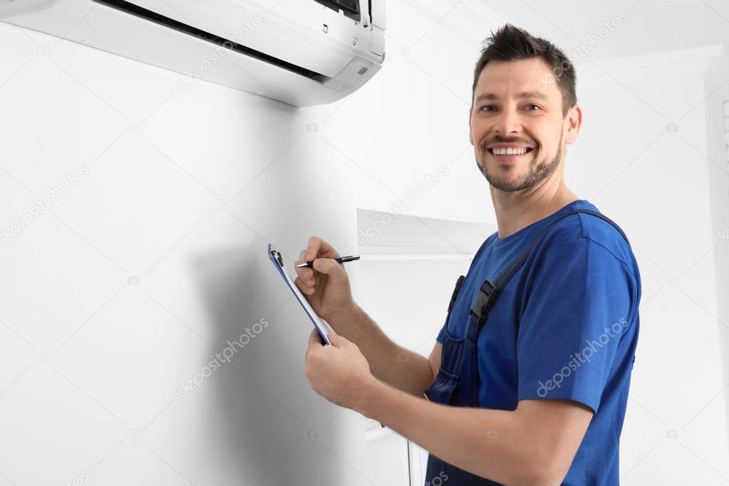 technician checking air conditioner