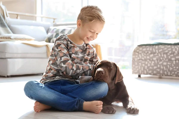 Милый маленький мальчик с собакой на полу дома — стоковое фото
