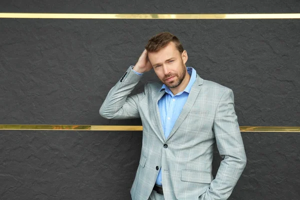 Man in formal suit near stone wall — Stock Photo, Image