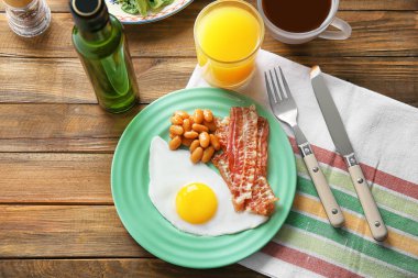 Tabak kızarmış yumurta, pastırma ve ahşap masa fasulye ile