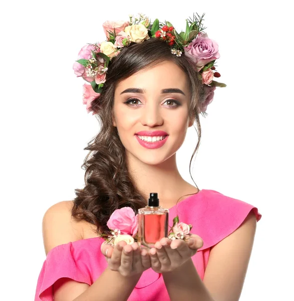 Beautiful young woman with bottle of floral perfume on white background — Stock Photo, Image