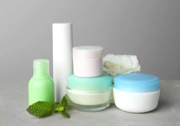 Set of body care products on grey background — Stock Photo, Image