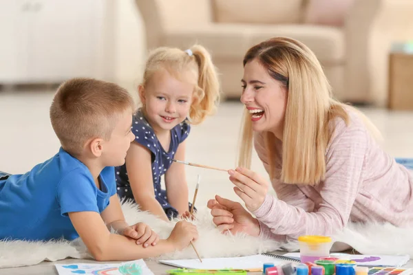 Mother with cute children painting, indoors — Stock Photo, Image