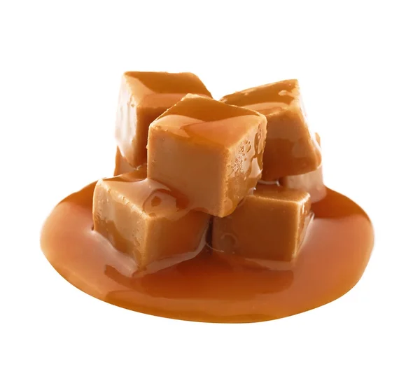 Delicious candies with caramel sauce on white background — Stock Photo, Image