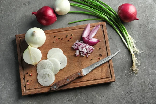 Samenstelling met verschillende uien op houten tafel — Stockfoto