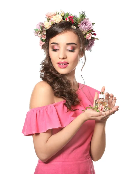 Beautiful young woman with bottle of floral perfume on white background — Stock Photo, Image