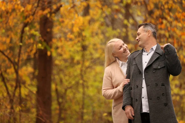 成熟夫妇在公园漫步在秋天的日子 — 图库照片
