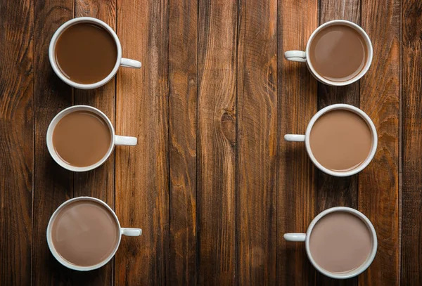 Cups with delicious coffee on wooden background — Stock Photo, Image