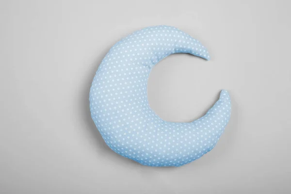 Soft pillow in shape of moon on light background — Stock Photo, Image