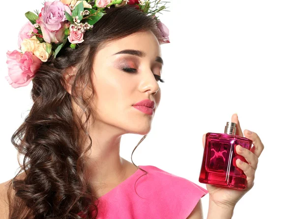 Beautiful young woman with bottle of floral perfume on white background — Stock Photo, Image