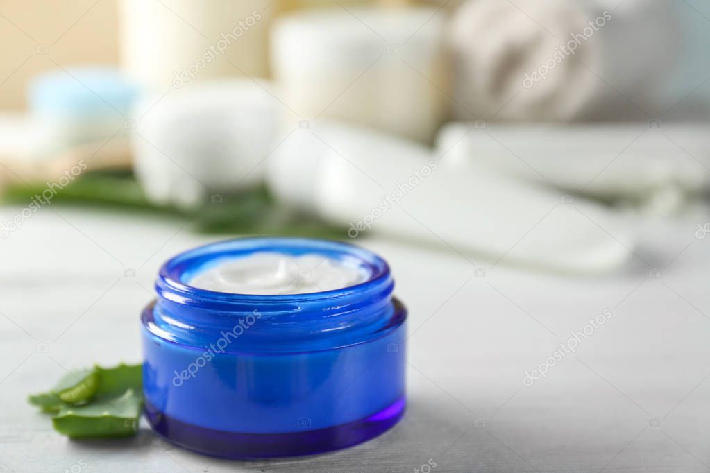 Jar with body cream on table