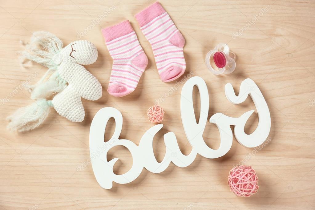 Gifts for baby shower on wooden background