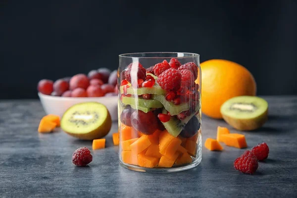 Delicious fruit salad in jar on table