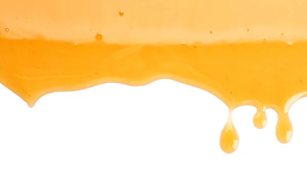 Dulce miel que fluye sobre fondo blanco — Foto de Stock