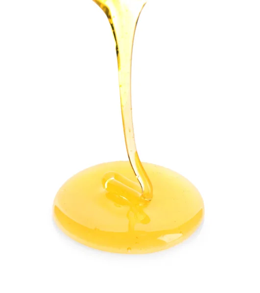 Dolce miele versando su sfondo bianco — Foto Stock