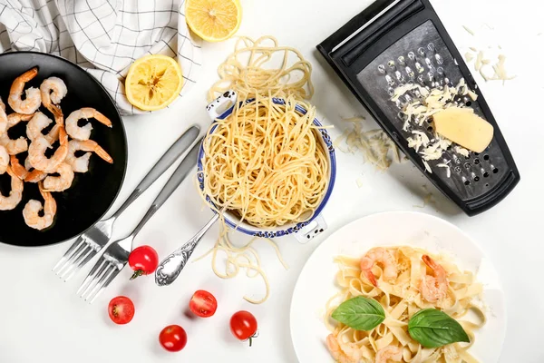 Composition with pasta and shrimps on table, top view
