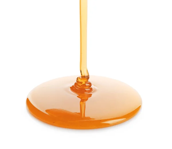 Dulce miel vertiendo sobre fondo blanco — Foto de Stock