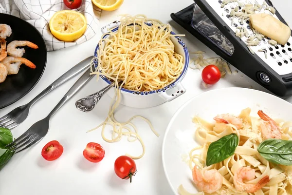 Composition with pasta and shrimps on table