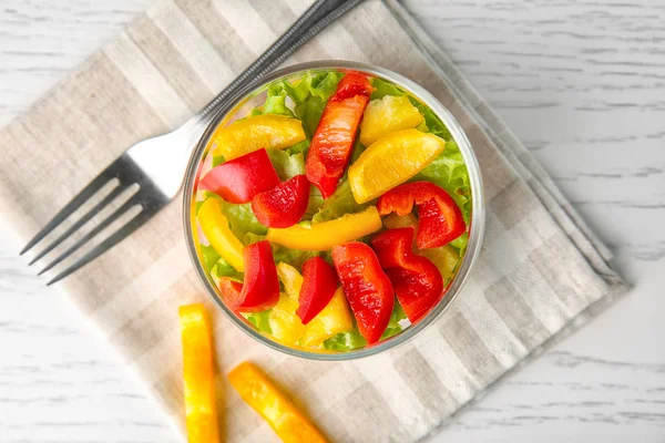 Delicious vegetable salad in jar on table