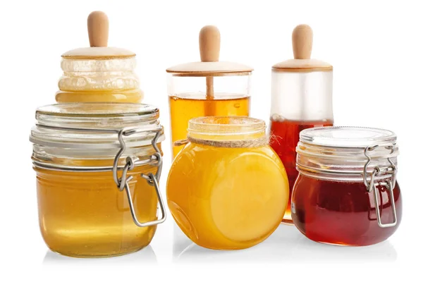 Jars with aromatic honey on white background — Stock Photo, Image