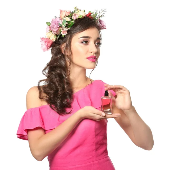 Beautiful young woman with bottle of floral perfume on white background — Stock Photo, Image