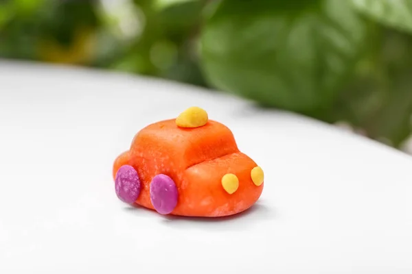 Car made from playdough on table against blurred background, closeup — Stock Photo, Image