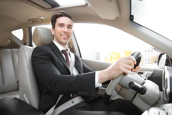 Businessman in driver's seat of car — Stock Photo, Image