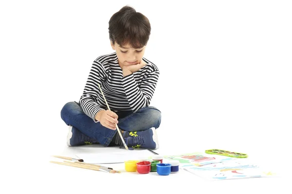 Little boy painting against white background — Stock Photo, Image