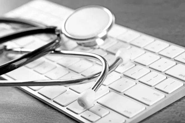 Stethoscope on computer keyboard, closeup — Stock Photo, Image