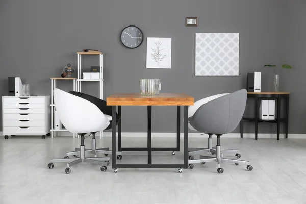 Interior de escritório moderno com mesa de madeira e poltronas — Fotografia de Stock