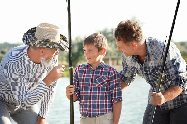 Family fishing on pond together — Stock Photo, Image
