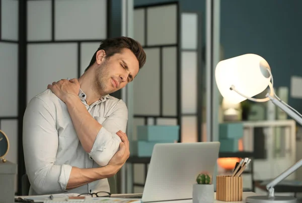 Tired young man working in office at night — Stock Photo, Image