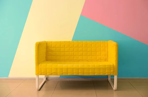 Comfortable armchair near color wall — Stock Photo, Image