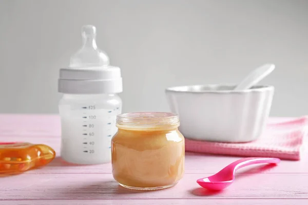 Composition with jar of healthy baby food on wooden table — Stock Photo, Image