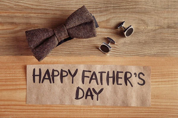 Composition with gifts for Father's day on wooden background