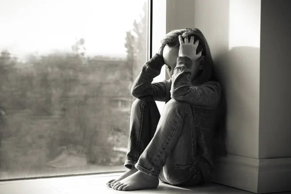 Little sad girl near window. Abuse of children concept — Stock Photo, Image