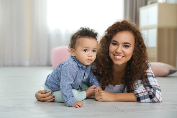 Cute baby and young mother at home — Stock Photo, Image