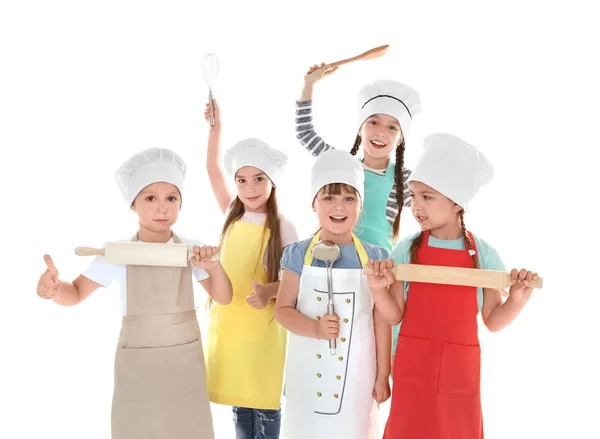 Cute children in aprons with kitchen utensils on white background — Stock Image Cute children in aprons with kitchen utensils on white background Royalty Free Stock Photos