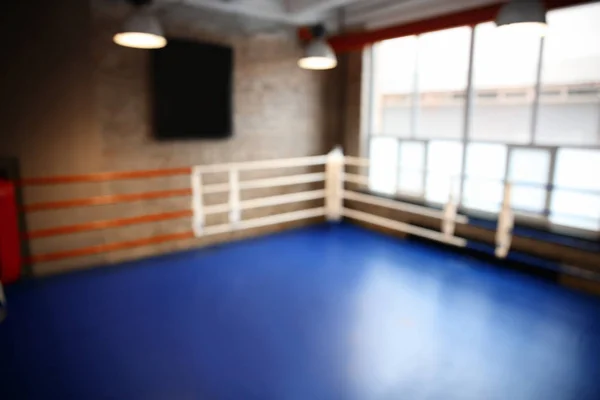 Blurred view of empty boxing ring indoors