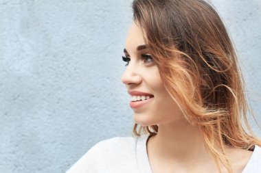 Işık arka plan üzerinde çekici gülümseyen kadın