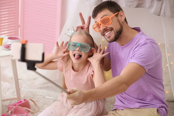 Father and his little daughter taking funny selfie at home — Stock Photo, Image