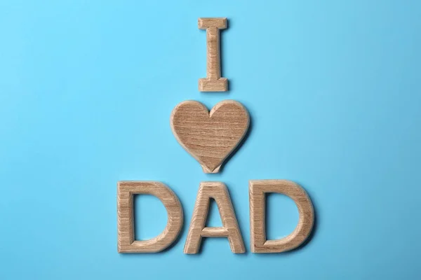 Composição com frase I LOVE DAD for Father 's Day on color background — Fotografia de Stock