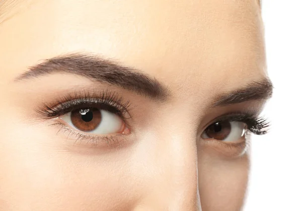 Beautiful young woman with eyelash extensions on white background, closeup — Stock Photo, Image