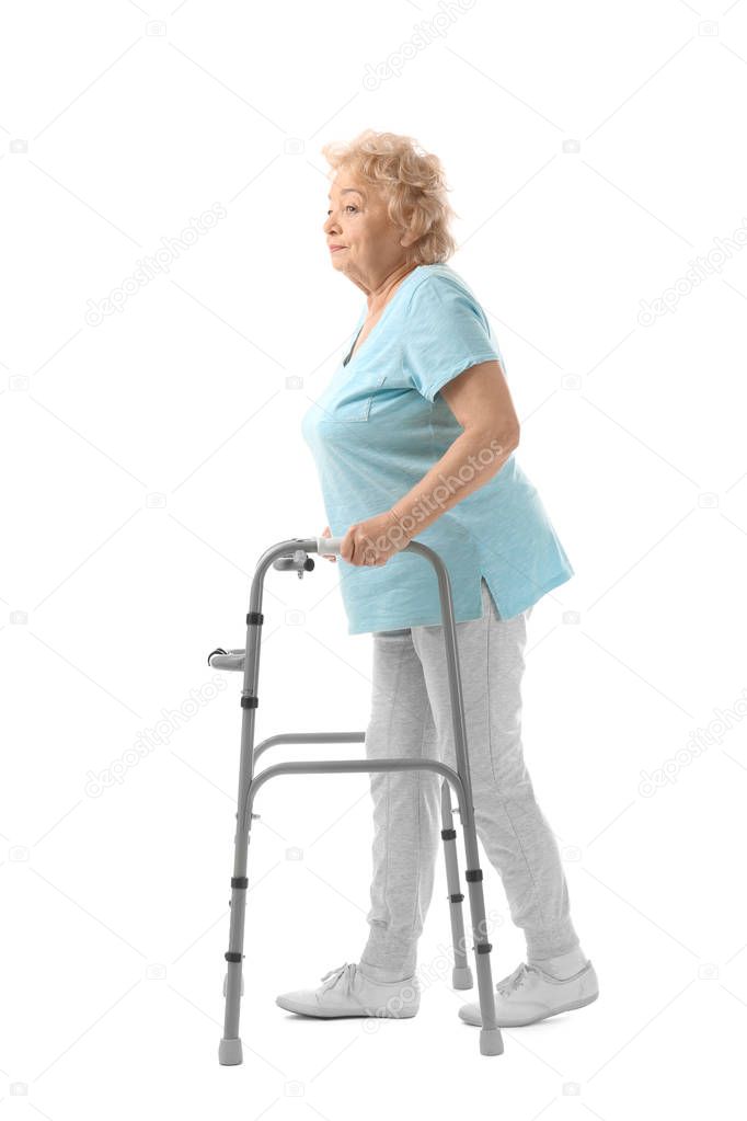 Elderly woman with walking frame on white background