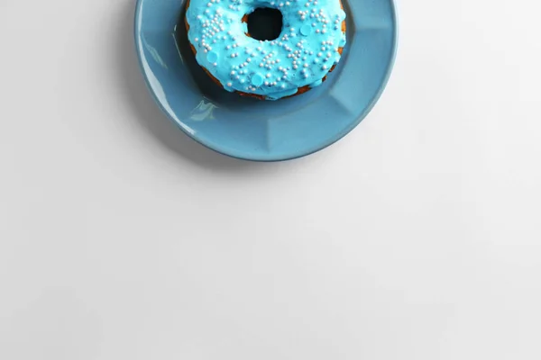 Teller mit blauem Donut auf weißem Hintergrund — Stockfoto