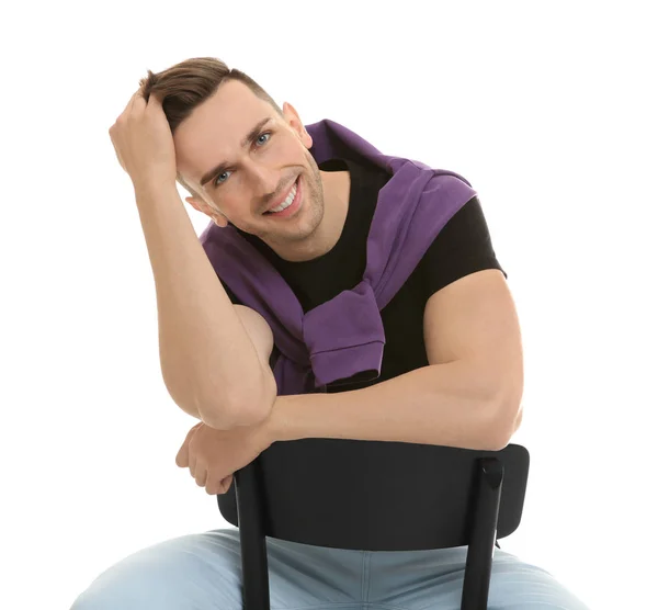 Handsome young man sitting on chair, isolated on white — Stock Photo, Image