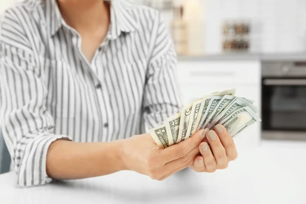 Woman holding money over table, closeup — Stock Photo, Image