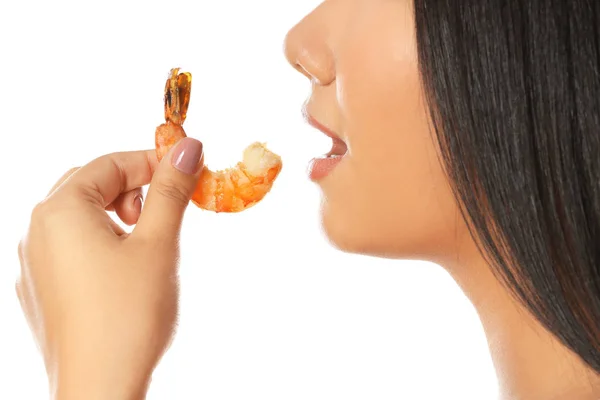Beautiful woman eating shrimp on white background — Stock Photo, Image