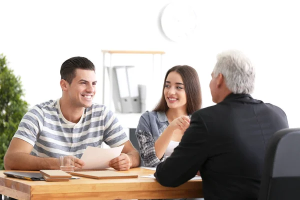 Young couple meeting with consultant in office — Stock Photo, Image